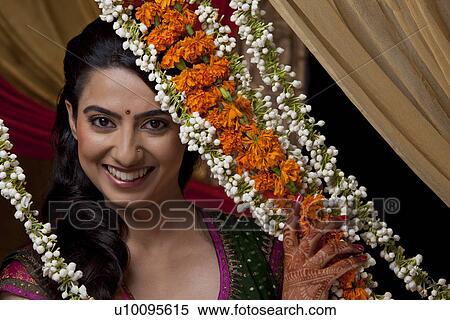 Stock Photography - Close-up portrait of smiling young Indian bride . Fotosearch