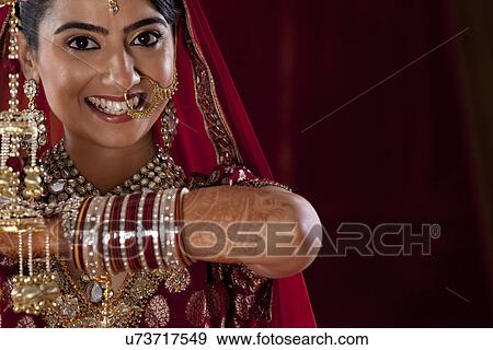 Close-up portrait of young woman in traditional jewelry View Large Photo Image Stock Photo - Close-up portrait of young woman in traditional jewelry . Fotosearch