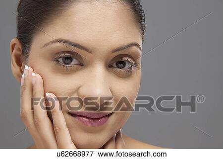 Close-up portrait of young woman over colored background View Large Photo Image Stock Photo - Close-up portrait of young woman over colored background . Fotosearch