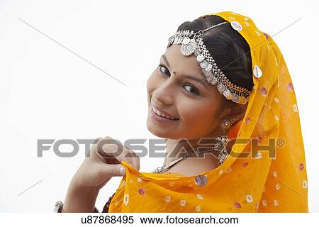 Stock Photography - Close-up portrait of young woman smiling against white background. Fotosearch