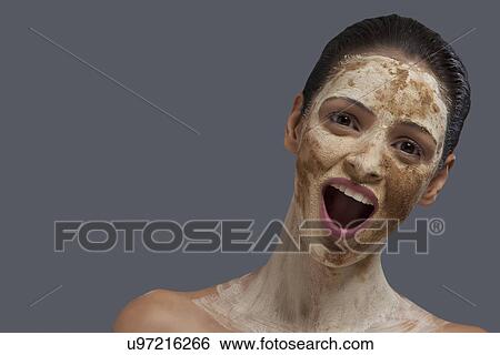 Close-up portrait of young woman with mouth open and face mask View Large Photo Image Stock Photograph - Close-up portrait of young woman with mouth open and face mask . Fotosearch