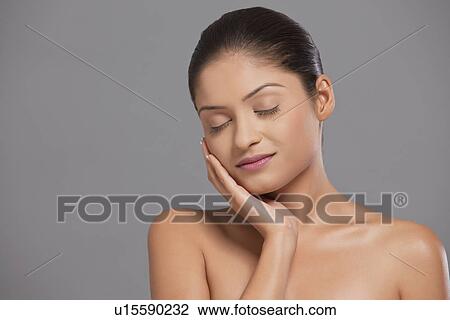 Close-up woman touching her face View Large Photo Image Stock Image - Close-up woman touching her face . Fotosearch