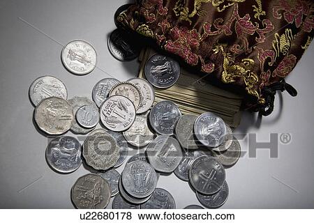 Stock Photo - Coins and currency notes . Fotosearch