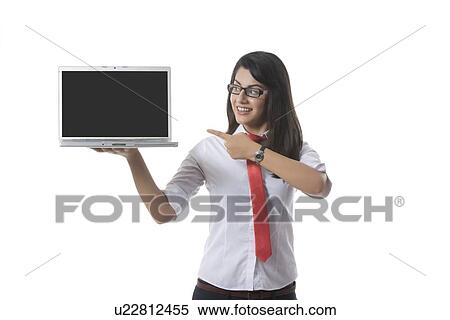 Confident businesswoman pointing at laptop over white background View Large Photo Image Stock Photography - Confident businesswoman pointing at laptop over white background. Fotosearch