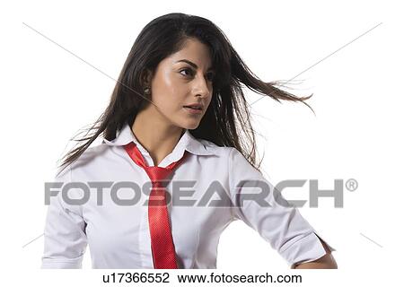 Stock Image - Confident fashionable businesswoman looking away over white background. Fotosearch
