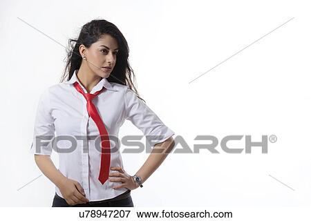 Confident fashionable businesswoman with hand on hip standing over white background View Large Photo Image Stock Photo - Confident fashionable businesswoman with hand on hip standing over white background. Fotosearch