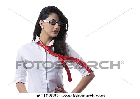 Stock Image - Confident stylish businesswoman with windswept tie over white background. Fotosearch