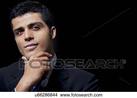 Confident young business man over black background View Large Photo Image Picture - Confident young business man over black background . Fotosearch