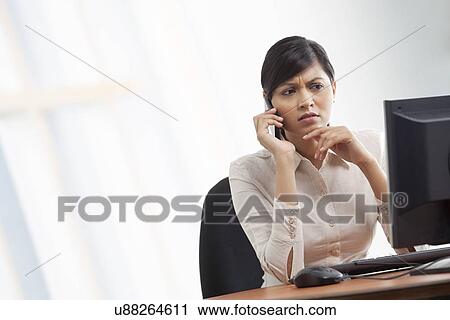 Contemplative businesswoman on call View Large Photo Image Stock Image - Contemplative businesswoman on call . Fotosearch