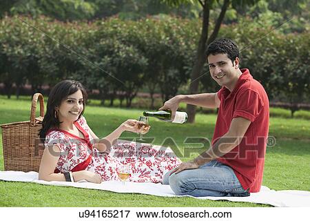Couple at a picnic View Large Photo Image Stock Photo - Couple at a picnic . Fotosearch