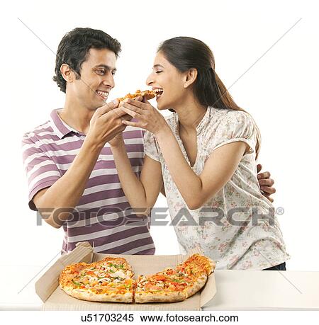 Stock Photography - Couple eating pizza . Fotosearch