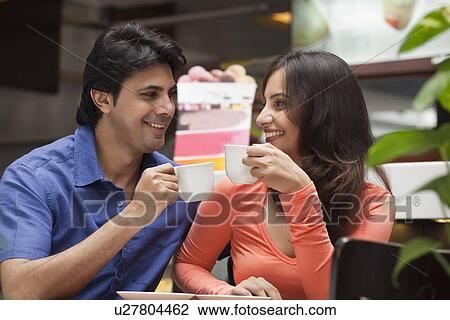 Couple enjoying a cup of tea in shopping mall View Large Photo Image Stock Image - Couple enjoying a cup of tea in shopping mall . Fotosearch