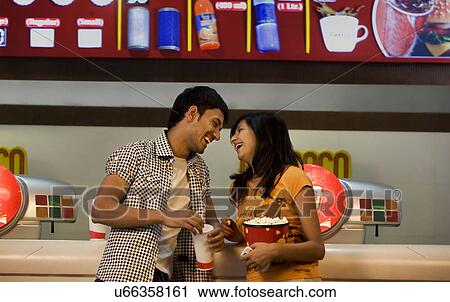 Stock Image - Couple enjoying themselves at a counter . Fotosearch