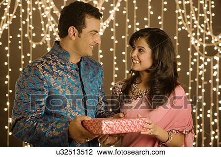 Couple exchanging presents View Large Photo Image Stock Image - Couple exchanging presents . Fotosearch