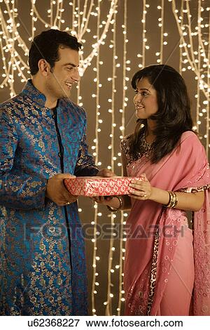 Couple exchanging presents View Large Photo Image Stock Photo - Couple exchanging presents . Fotosearch