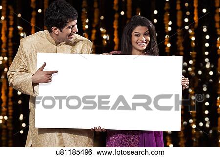 Stock Photograph - Couple holding a white board. Fotosearch