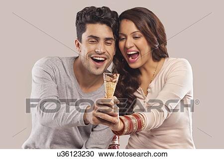 Couple holding an ice cream cone View Large Photo Image Stock Image - Couple holding an ice cream cone. Fotosearch