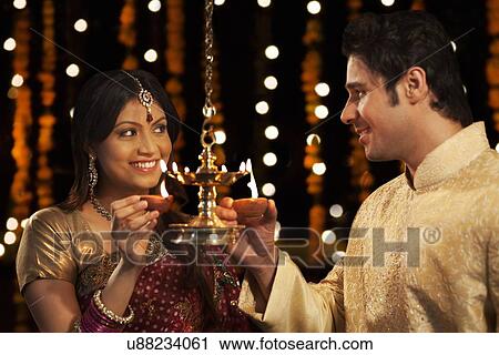 Couple holding diyas View Large Photo Image Stock Image - Couple holding diyas. Fotosearch