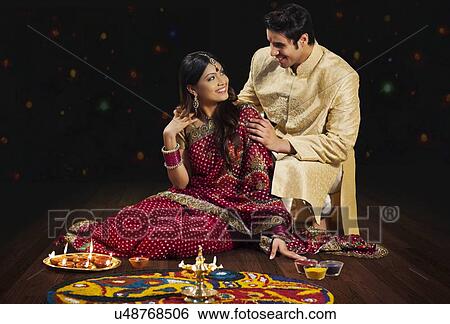 Couple in front of rangoli View Large Photo Image Stock Photograph - Couple in front of rangoli. Fotosearch