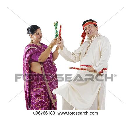Couple performing dandiya dance View Large Photo Image Stock Image - Couple performing dandiya dance . Fotosearch