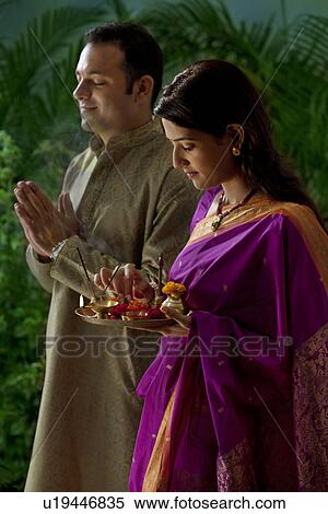 Couple praying during diwali View Large Photo Image Stock Photography - Couple praying during diwali . Fotosearch
