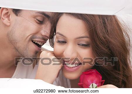 Couple romancing in bed View Large Photo Image Stock Image - Couple romancing in bed. Fotosearch