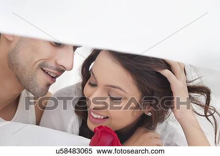 Couple romancing in bed View Large Photo Image Stock Photography - Couple romancing in bed. Fotosearch