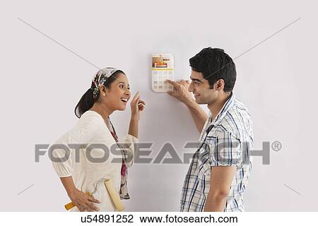 Couple selecting color for their wall View Large Photo Image Stock Image - Couple selecting color for their wall . Fotosearch