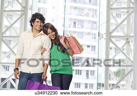 Stock Image - Couple spending time together while shopping . Fotosearch