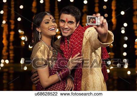 Couple taking a self portrait View Large Photo Image Stock Image - Couple taking a self portrait. Fotosearch
