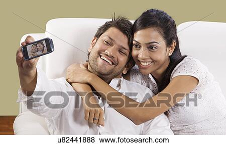 Couple taking a self portrait View Large Photo Image Stock Photo - Couple taking a self portrait . Fotosearch