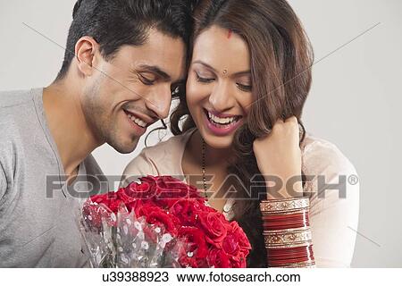 Couple with a bouquet of flowers View Large Photo Image Stock Image - Couple with a bouquet of flowers. Fotosearch