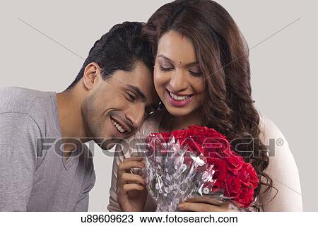 Couple with a bouquet of flowers View Large Photo Image Stock Image - Couple with a bouquet of flowers. Fotosearch