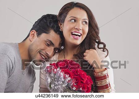 Stock Photo - Couple with a bouquet of flowers. Fotosearch
