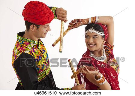 Stock Image - Couple with sticks dancing . Fotosearch
