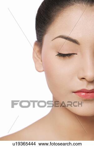 Picture - Cropped image of a smiling young woman with eyes closed . Fotosearch