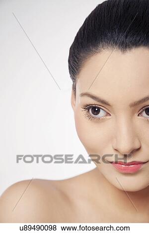 Cropped image of a young woman looking away over white background View Large Photo Image Stock Photo - Cropped image of a young woman looking away over white background . Fotosearch