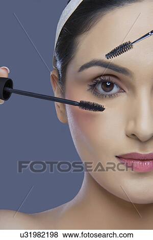 Cropped image of pretty young woman with mascara and eyebrow tinting applicator over colored background View Large Photo Image Stock Photo - Cropped image of pretty young woman with mascara and eyebrow tinting applicator over colored background . Fotosearch