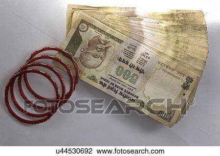 Stock Image - Currency and jewelery . Fotosearch