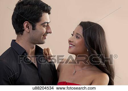 Cute Indian couple looking at each other with love View Large Photo Image Picture - Cute Indian couple looking at each other with love . Fotosearch