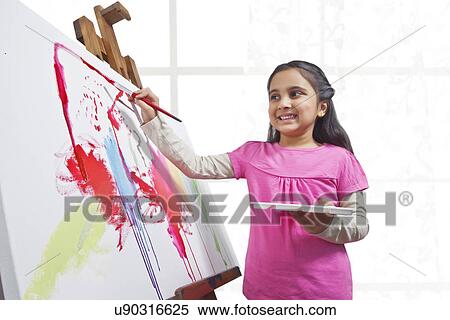 Cute little girl painting on canvas during art class View Large Photo Image Stock Photography - Cute little girl painting on canvas during art class . Fotosearch