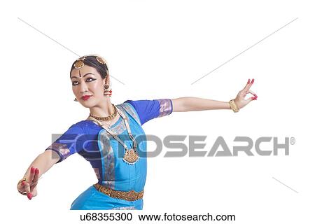 Stock Image - Dancer performing Bharatanatyam against white background. Fotosearch
