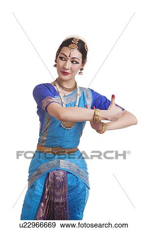 Dancer performing Bharatanatyam against white background View Large Photo Image Stock Photo - Dancer performing Bharatanatyam against white background. Fotosearch