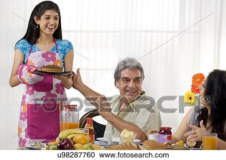 Daughter serving her family View Large Photo Image Stock Image - Daughter serving her family . Fotosearch
