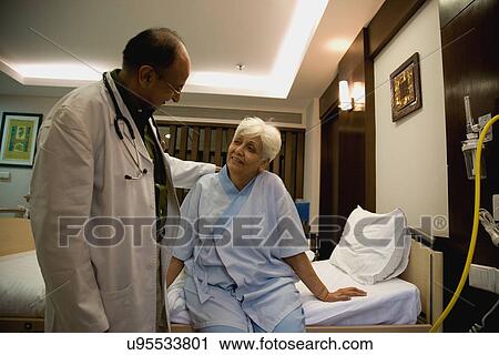Stock Image - Doctor with his patient . Fotosearch
