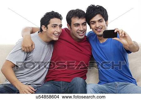 Picture - Excited young friends talking self portrait photograph . Fotosearch