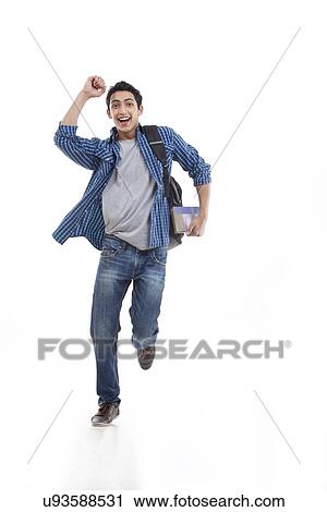 Stock Image - Excited young man running over white background . Fotosearch