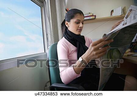 Executive looking at the newspaper View Large Photo Image Stock Image - Executive looking at the newspaper . Fotosearch