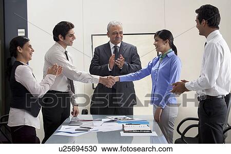 Stock Image - Executives applauding on business agreement . Fotosearch
