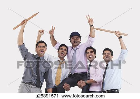 Stock Image - Executives cheering during cricket match . Fotosearch